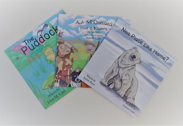 A picture with three of our children's books on display